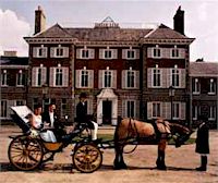 A couple sitting in a carriage outside York House