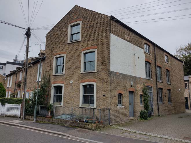 Fig. 39: The presence of the mews is indicated by a surviving industrial building rising directly from the pavement
